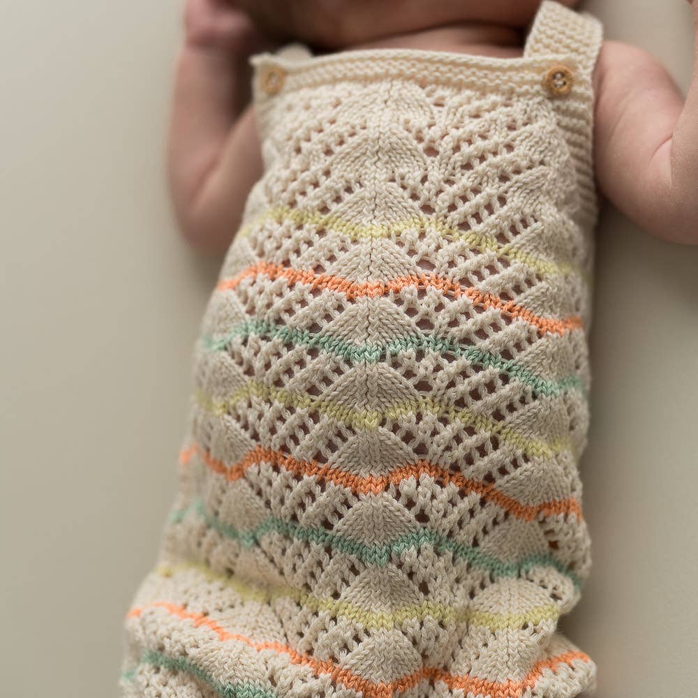 Knitted romper in lace pattern - organic