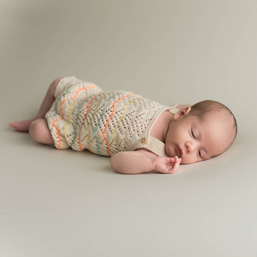 Knitted romper in lace pattern - organic