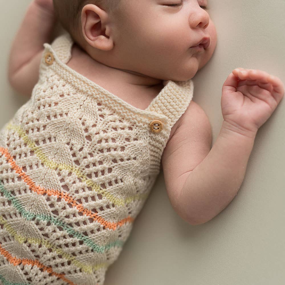 Knitted romper in lace pattern - organic
