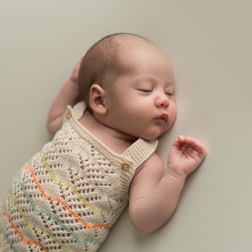 Knitted romper in lace pattern - organic